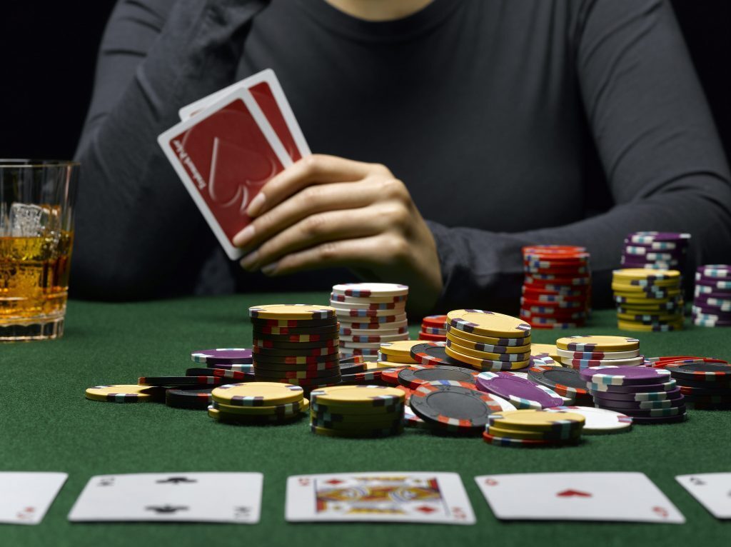 woman with hand of cards playing poker