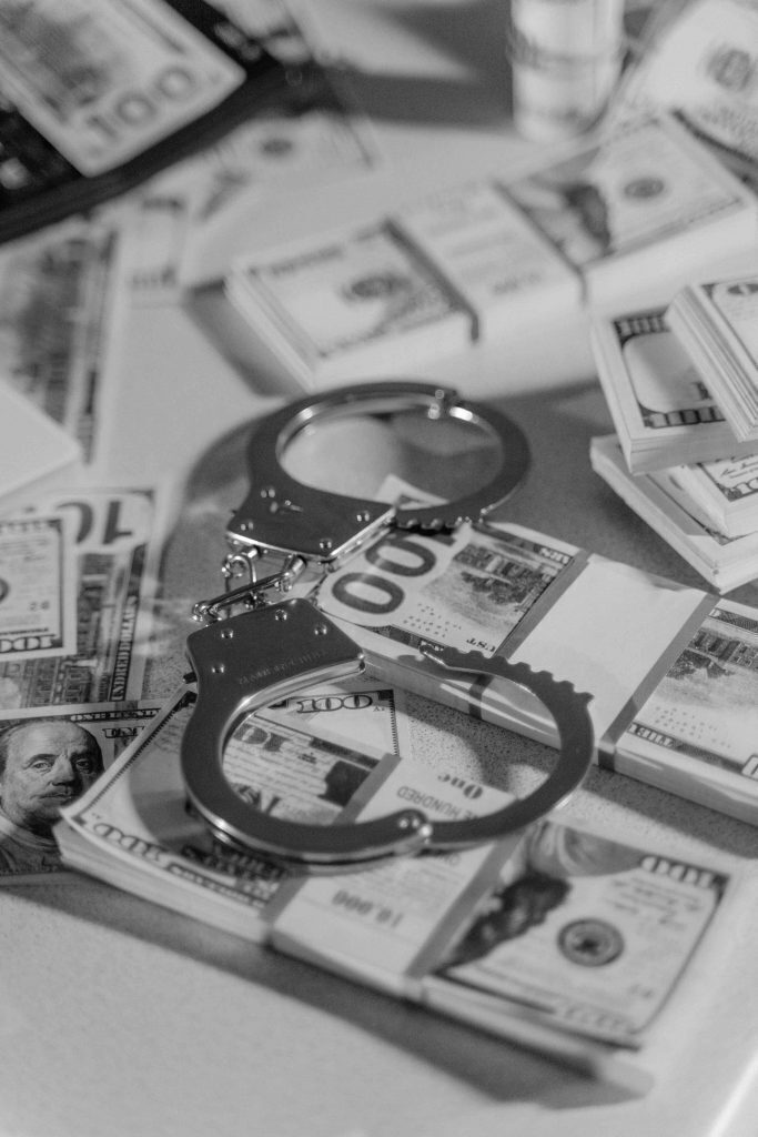 handcuffs on stacks of money